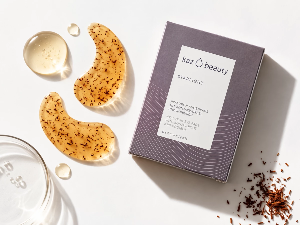 KAZ Beauty Starlight box with golden eye pads, serum droplets and rooibos on a white surface