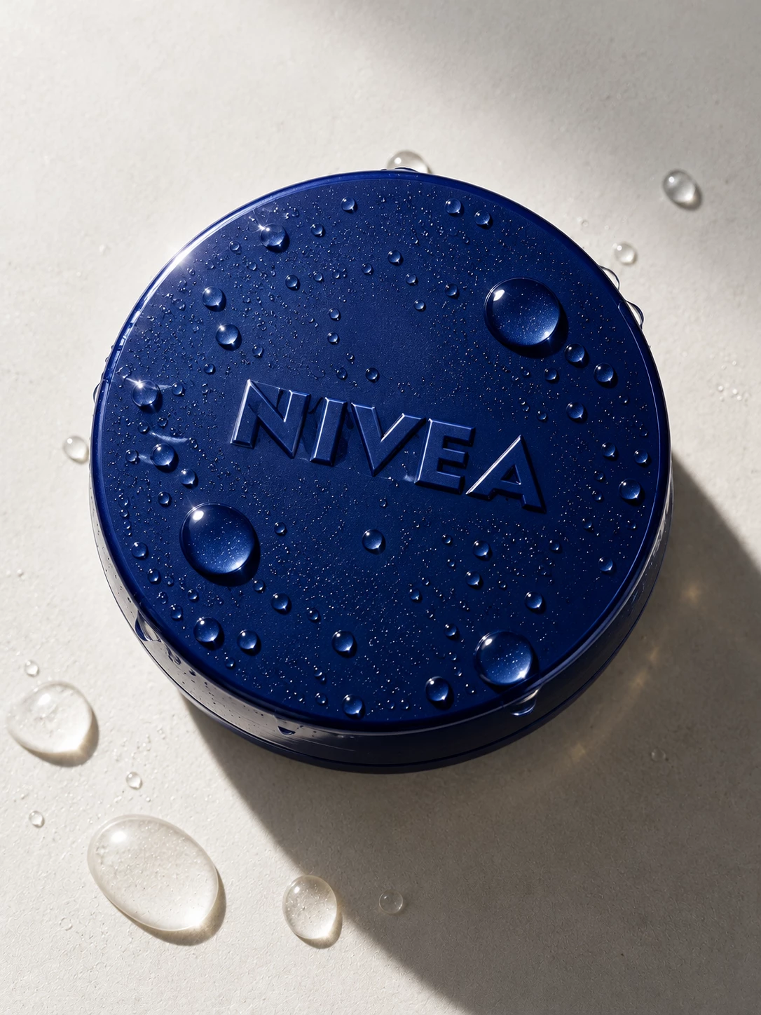 Blue Nivea cream tin with embossed logo and water droplets