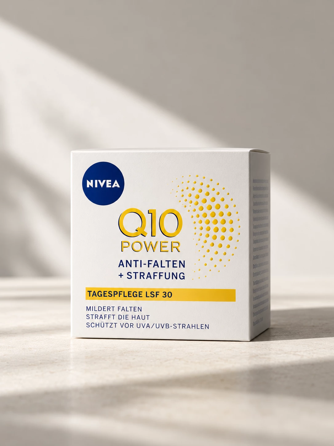Nivea Q10 Power skincare packaging in warm directional light