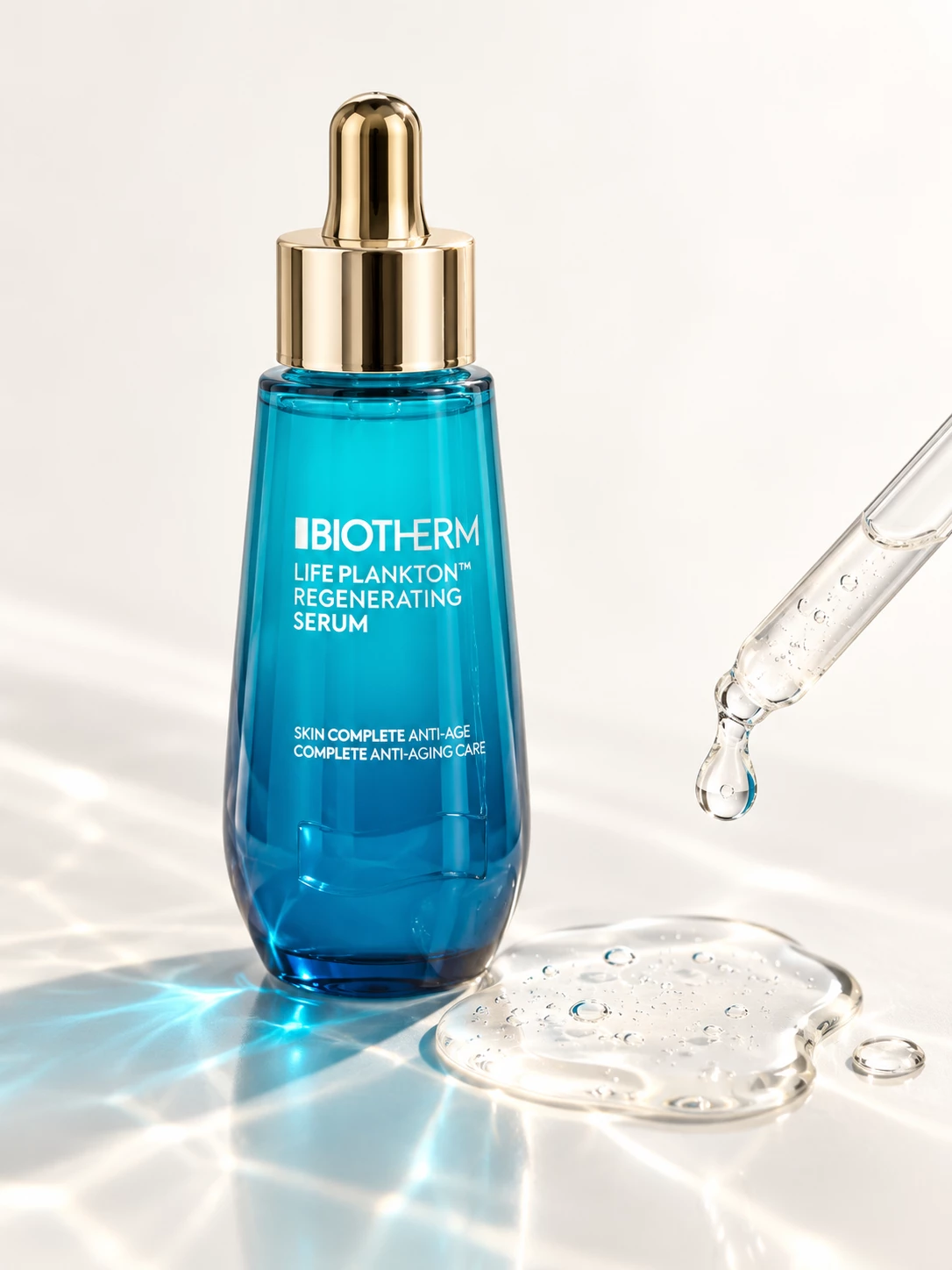 Biotherm serum bottle beside a pipette and clear gel droplets