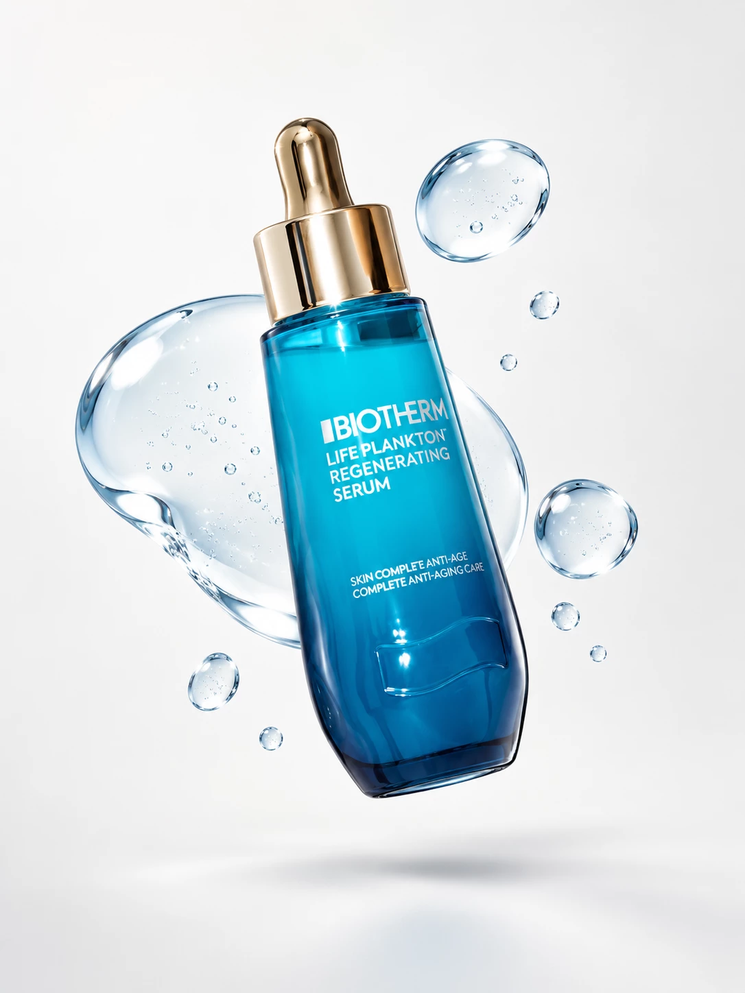 Blue Biotherm serum bottle suspended among transparent droplets