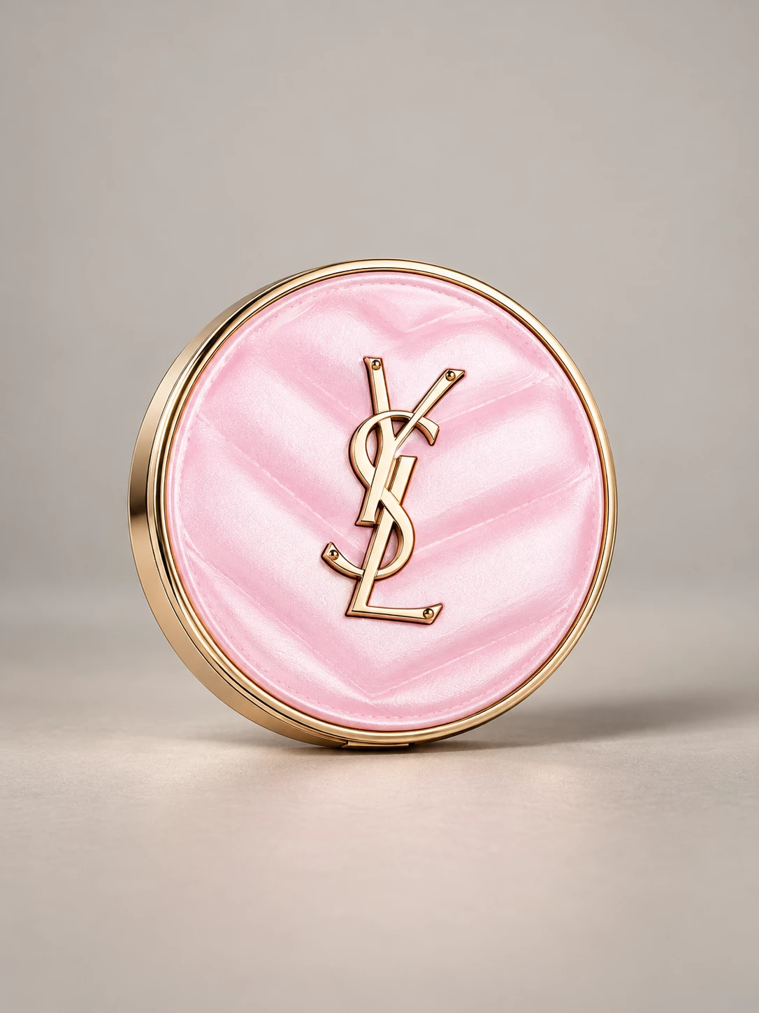 Upright pink YSL compact with gold rim and logo