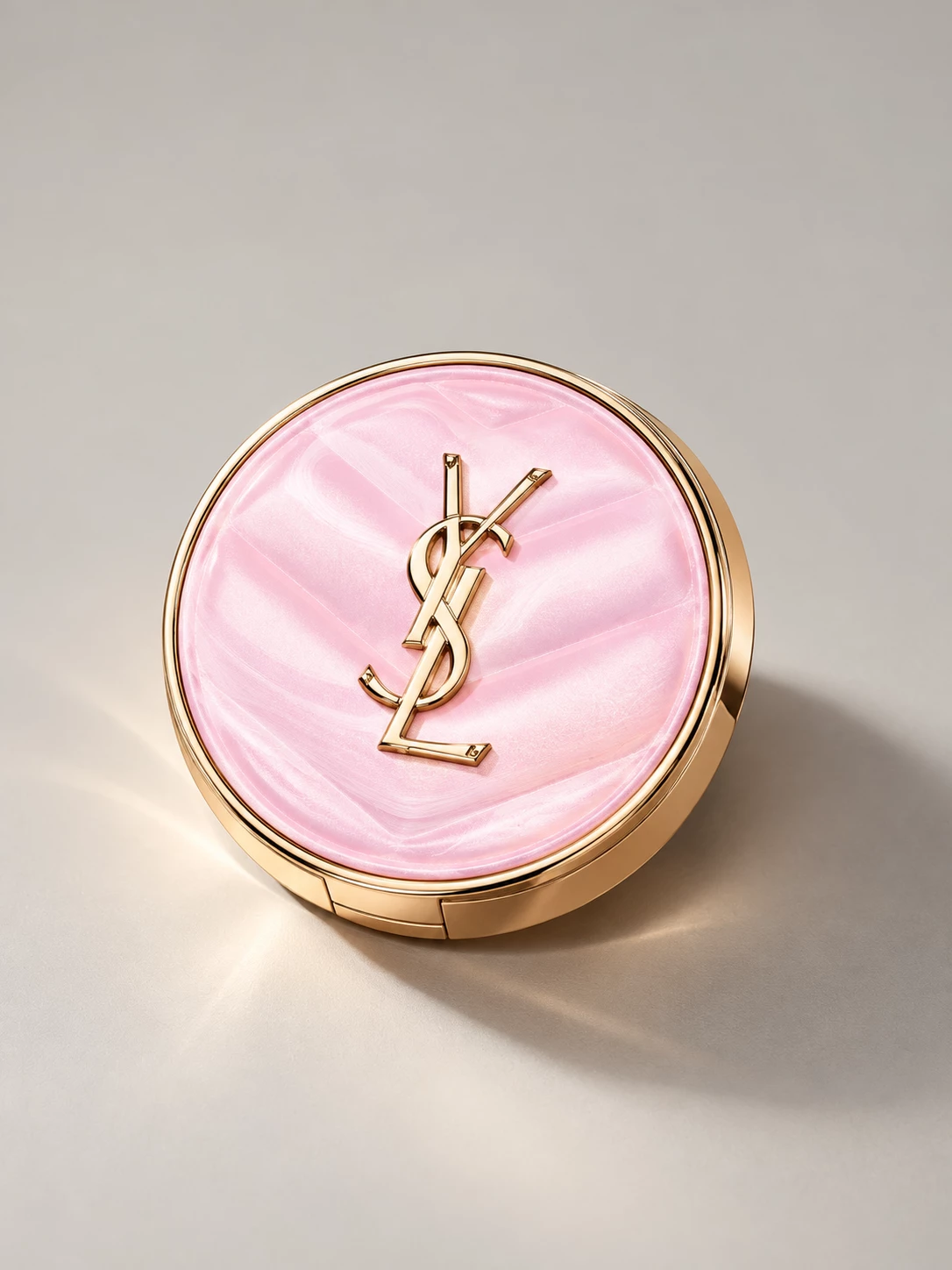 Pink YSL compact resting at an angle in soft light