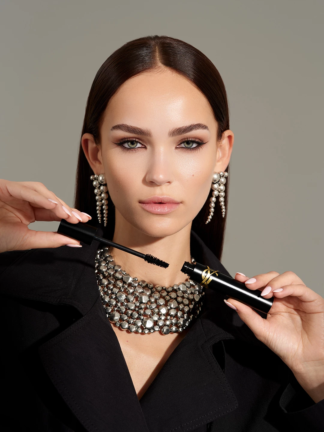 Julia Wess holding an open black and gold YSL mascara