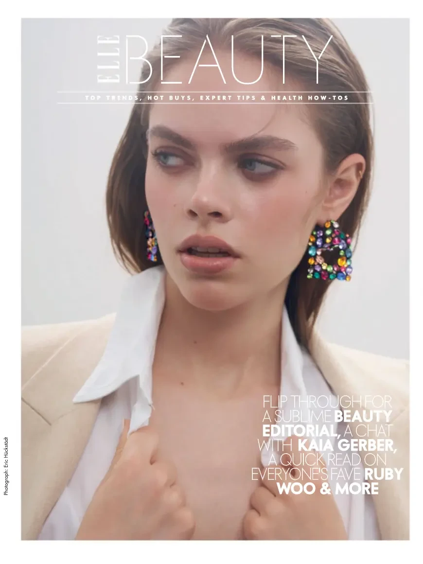 ELLE Beauty magazine cover showing a model in a white shirt with colorful earrings